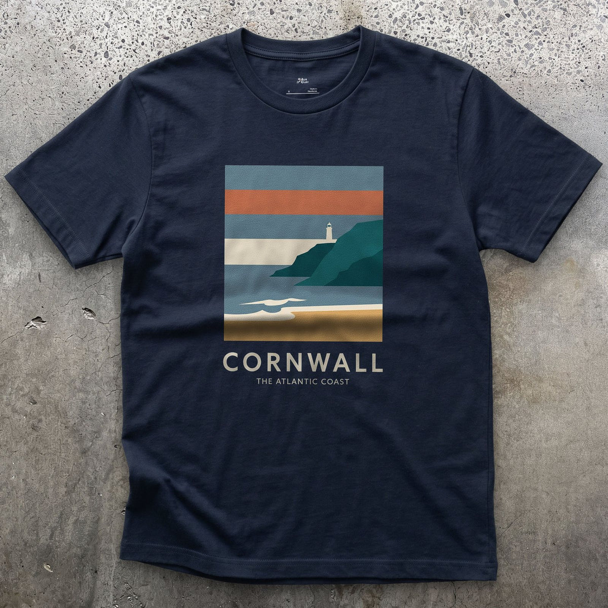 Lighthouse Above the Cornish Coast design on a Navy Gildan Softstyle t-shirt