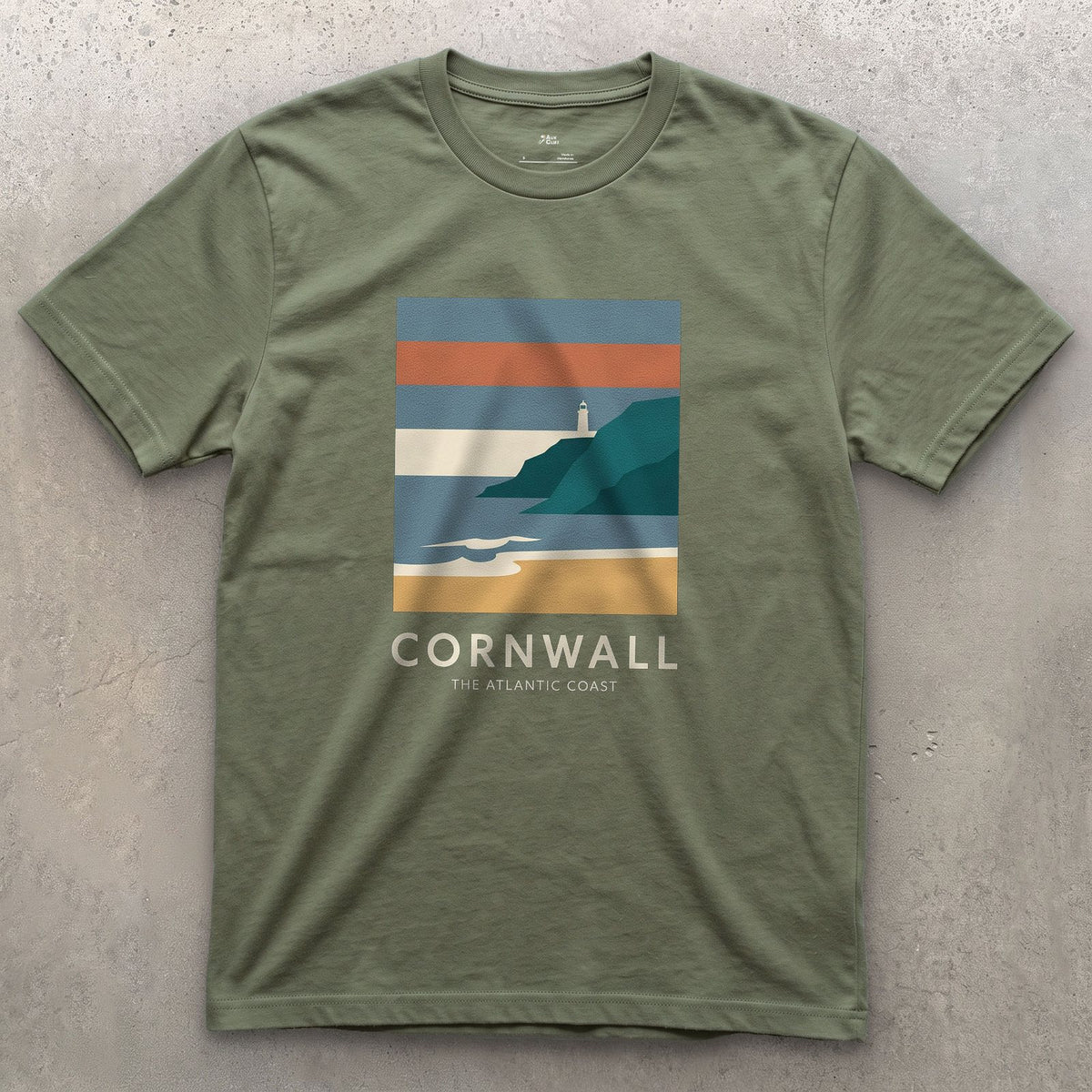 Lighthouse Above the Cornish Coast design on a Military Green Gildan Softstyle t-shirt