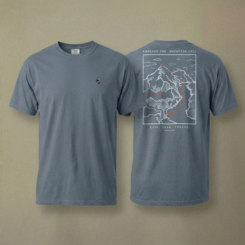 AukCliff Everest tee in Blue Jean, hand-drawn summit-route line art across the back
