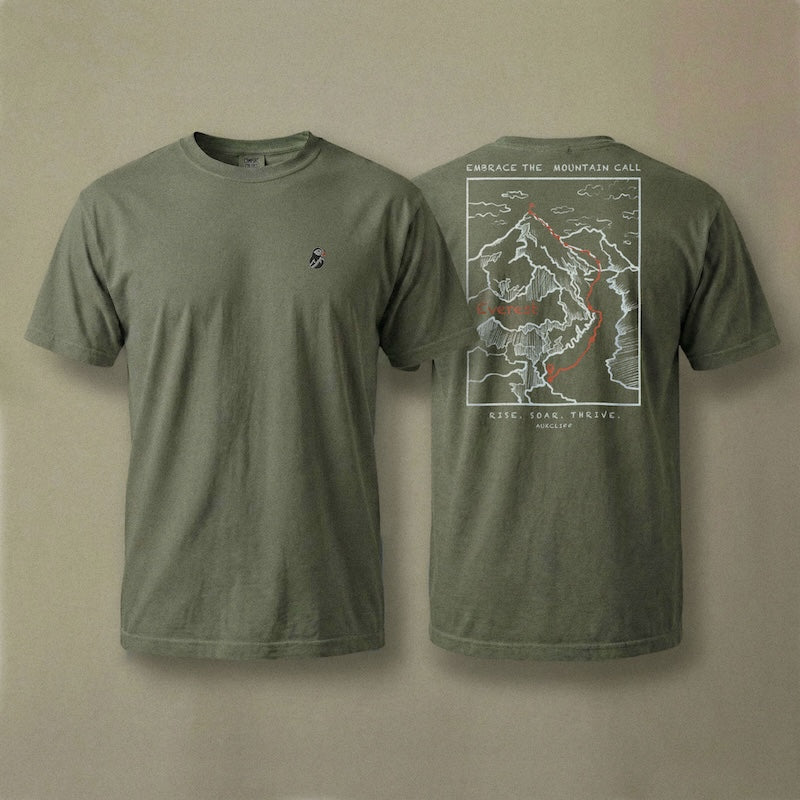 AukCliff Everest tee in Blue Jean, hand-drawn summit-route line art across the back
