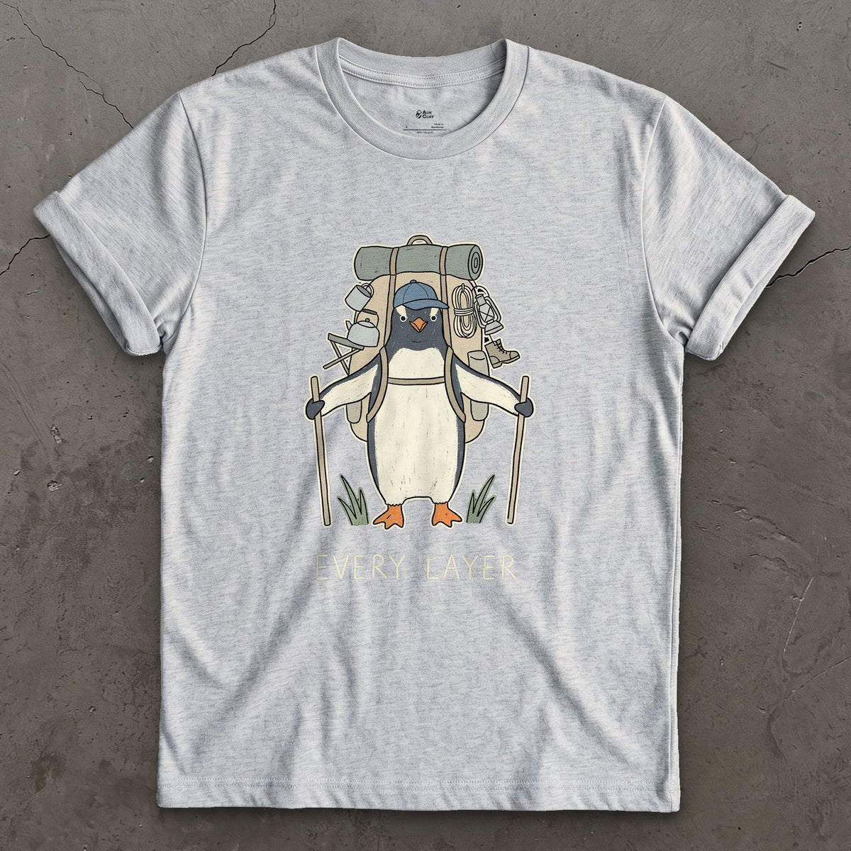 Doesn't Trust the Forecast, Penguin Hiker design on a Sport Grey Gildan Softstyle t-shirt