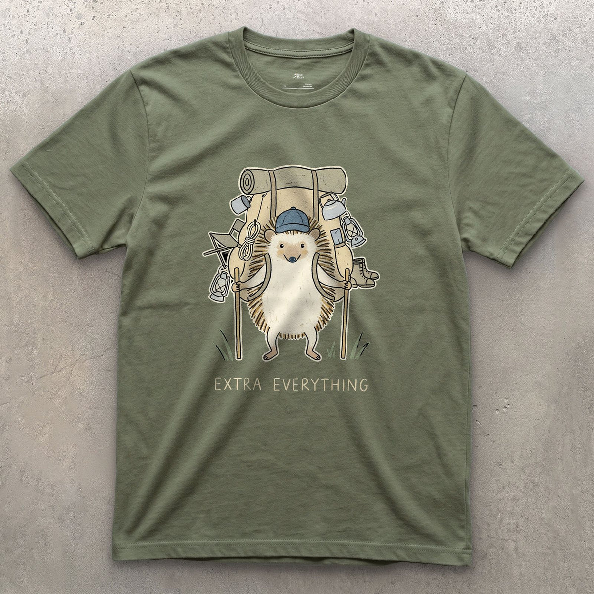 Never Packs Light, Hedgehog Hiker design on a Military Green Gildan Softstyle t-shirt