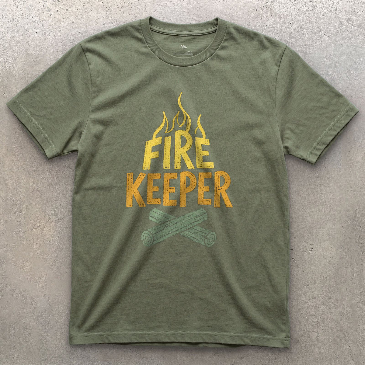 Fire Keeper, Crossed Logs at Camp design on a Military Green Gildan Softstyle t-shirt