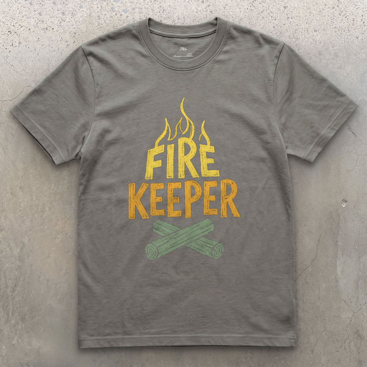 Fire Keeper, Crossed Logs at Camp design on a Charcoal Gildan Softstyle t-shirt