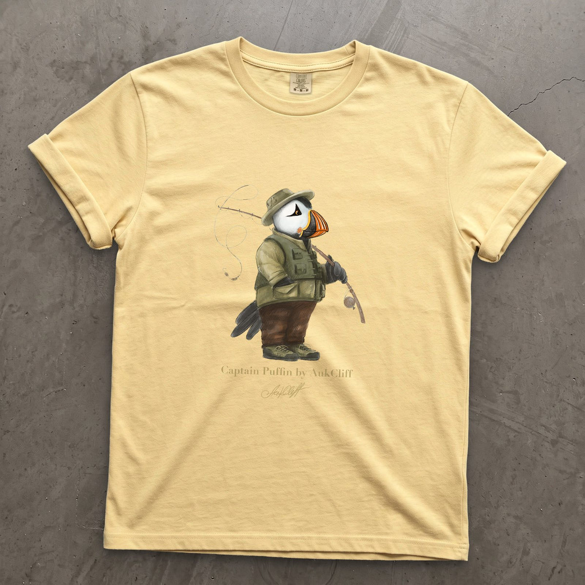 Captain Puffin Fly Fisherman on a Butter Comfort Colors t-shirt