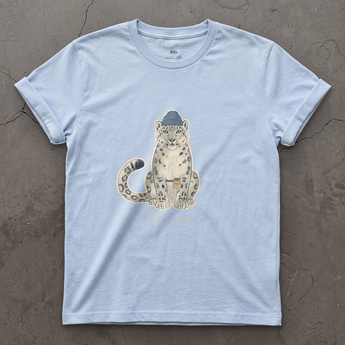 Free Solo Climber, Snow Leopard in a Beanie design on a Light Blue Gildan Softstyle t-shirt