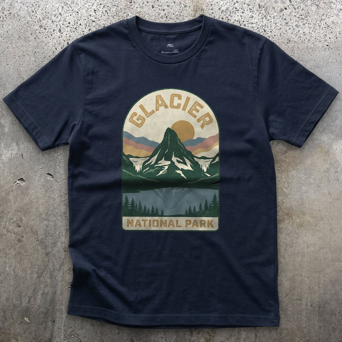 Glacier National Park Badge design on a Navy Gildan Softstyle t-shirt