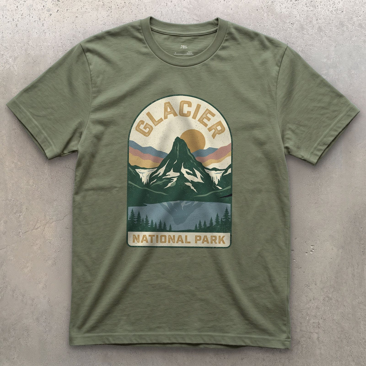 Glacier National Park Badge design on a Military Green Gildan Softstyle t-shirt