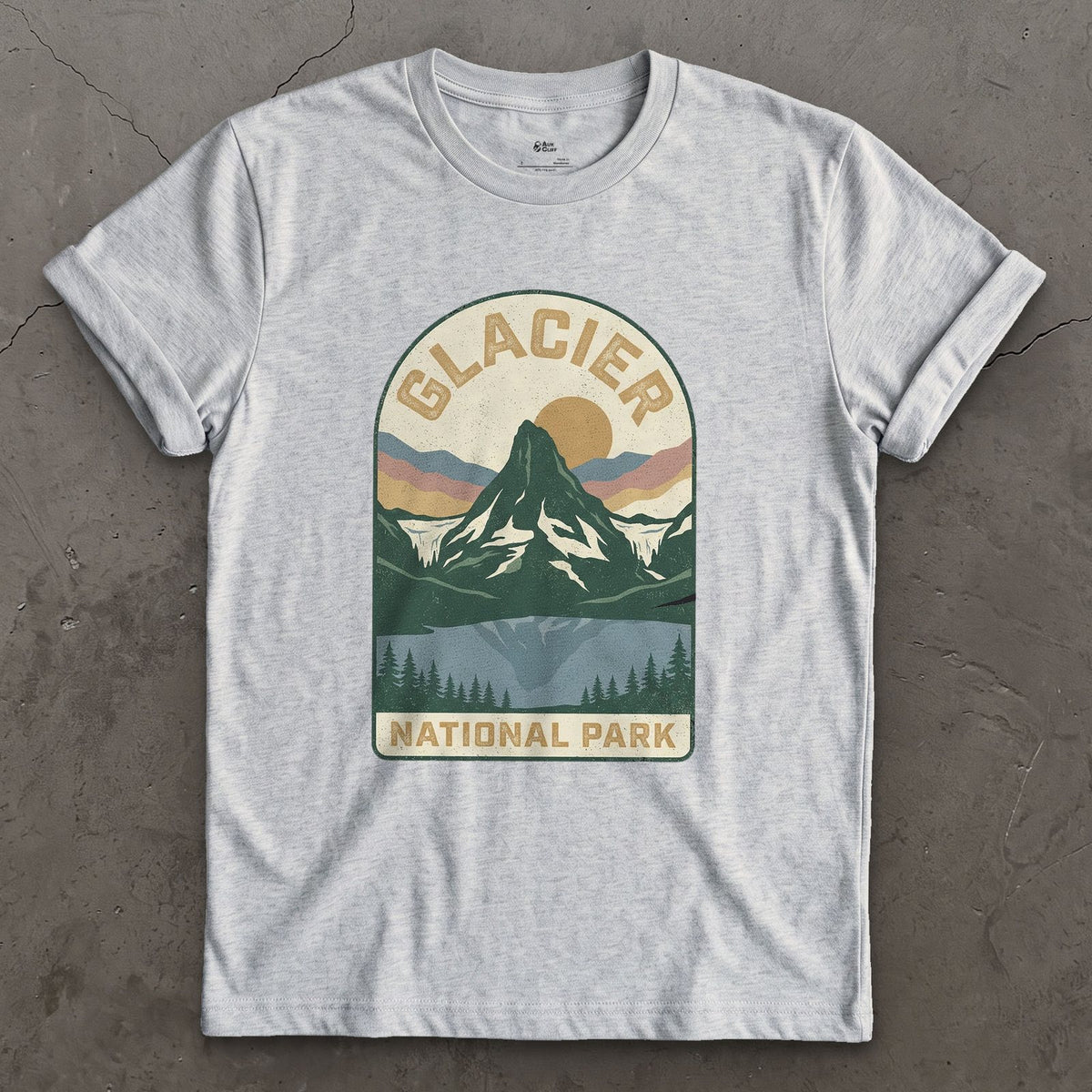 Glacier National Park Badge design on a Sport Grey Gildan Softstyle t-shirt