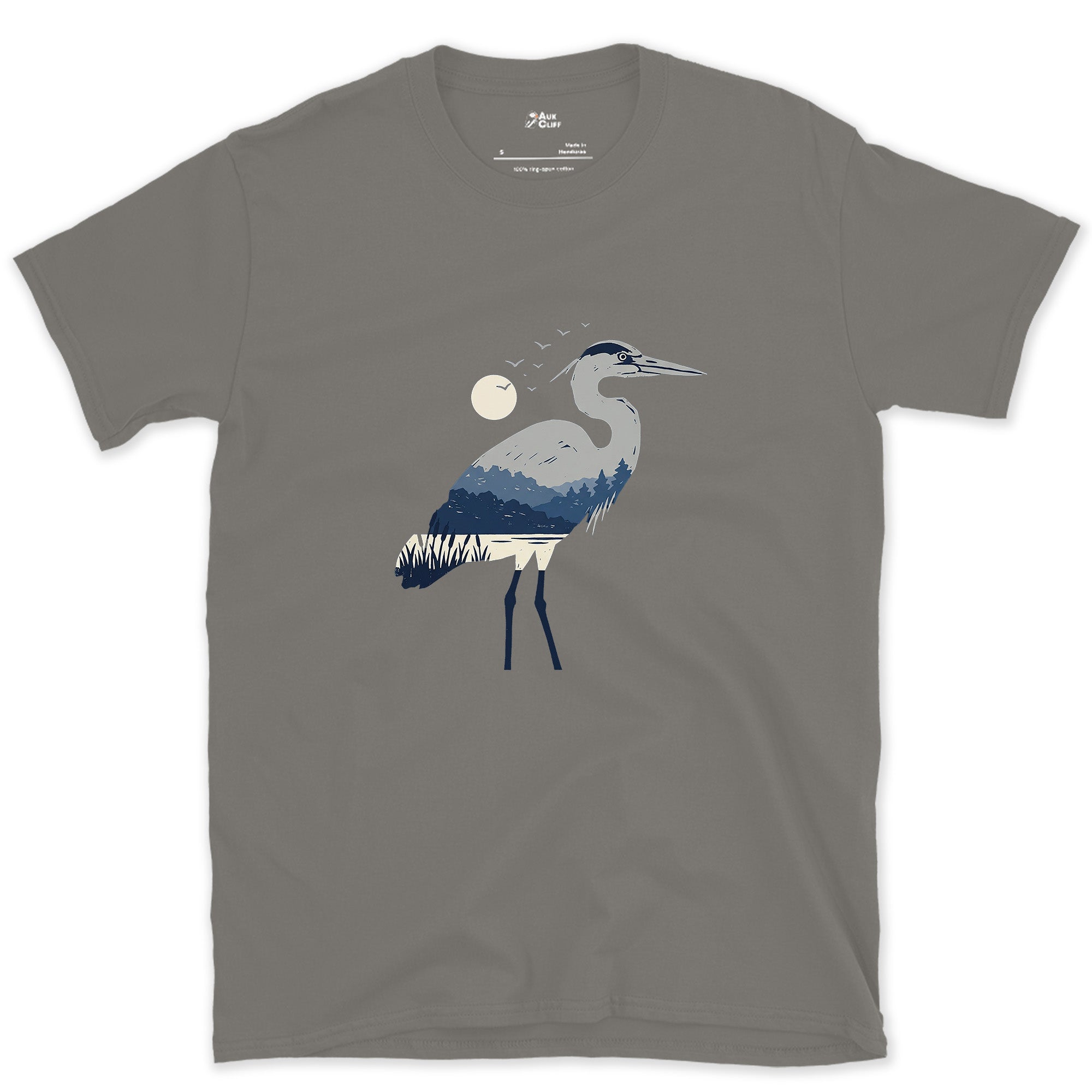 The Heron Holding a Whole Landscape Inside It design on a Charcoal Gildan Softstyle t-shirt