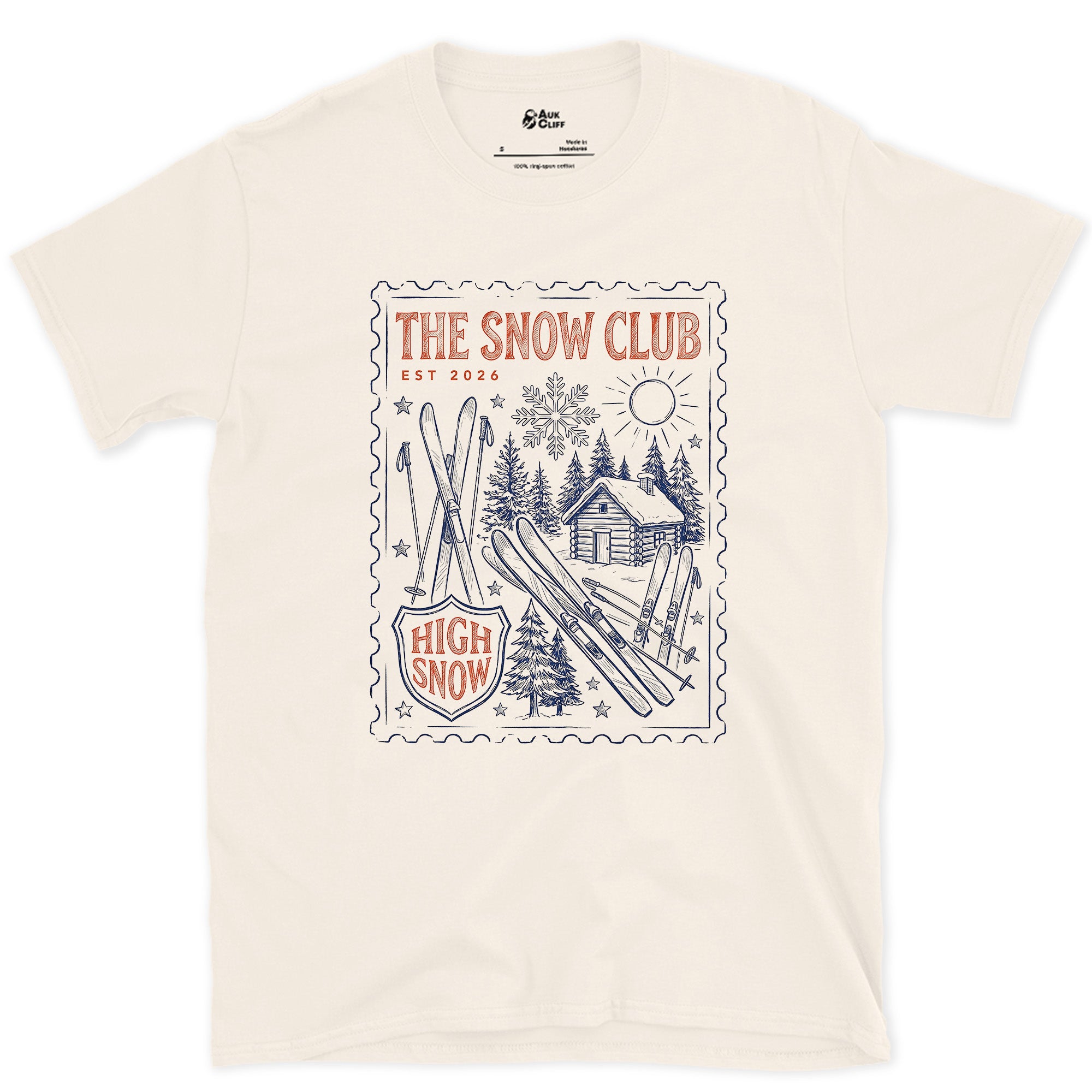 The Snow Club, Stamped With a Cabin and Skis design on a Natural Gildan Softstyle t-shirt