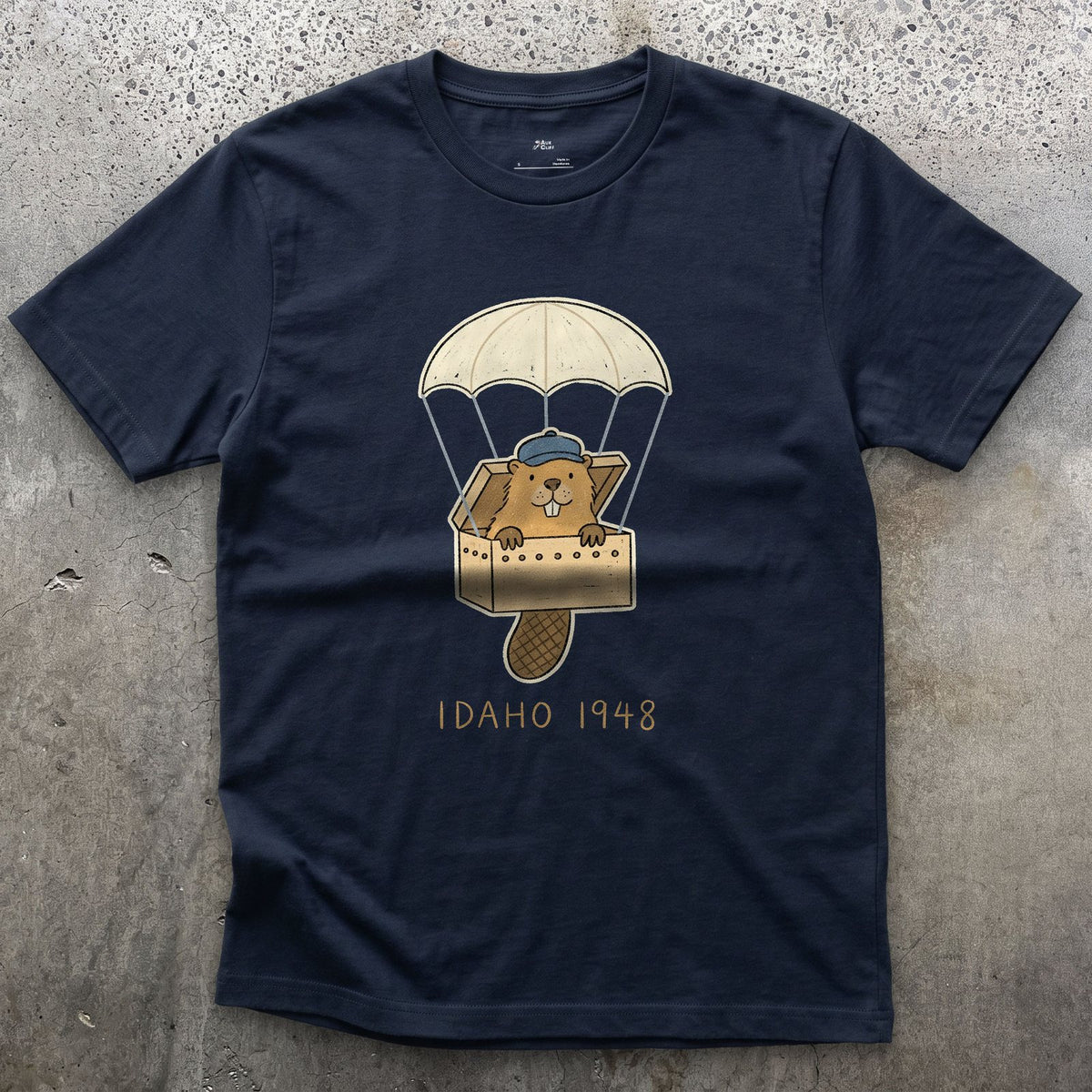 Idaho 1948, Beaver Airdrop Into the Wild design on a Navy Gildan Softstyle t-shirt