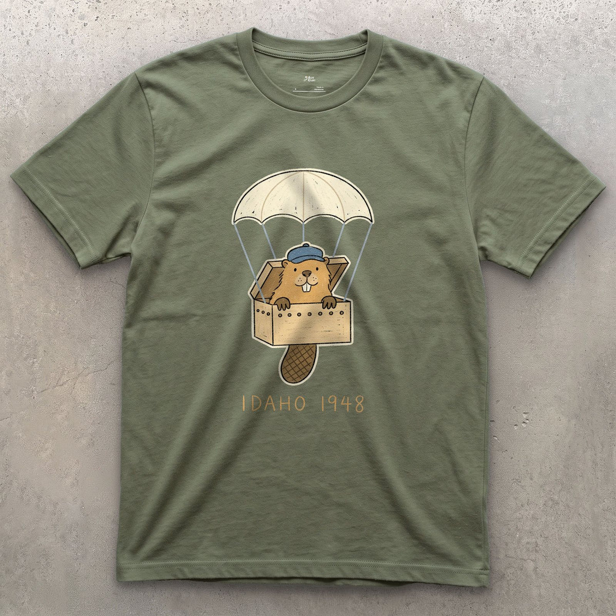 Idaho 1948, Beaver Airdrop Into the Wild design on a Military Green Gildan Softstyle t-shirt