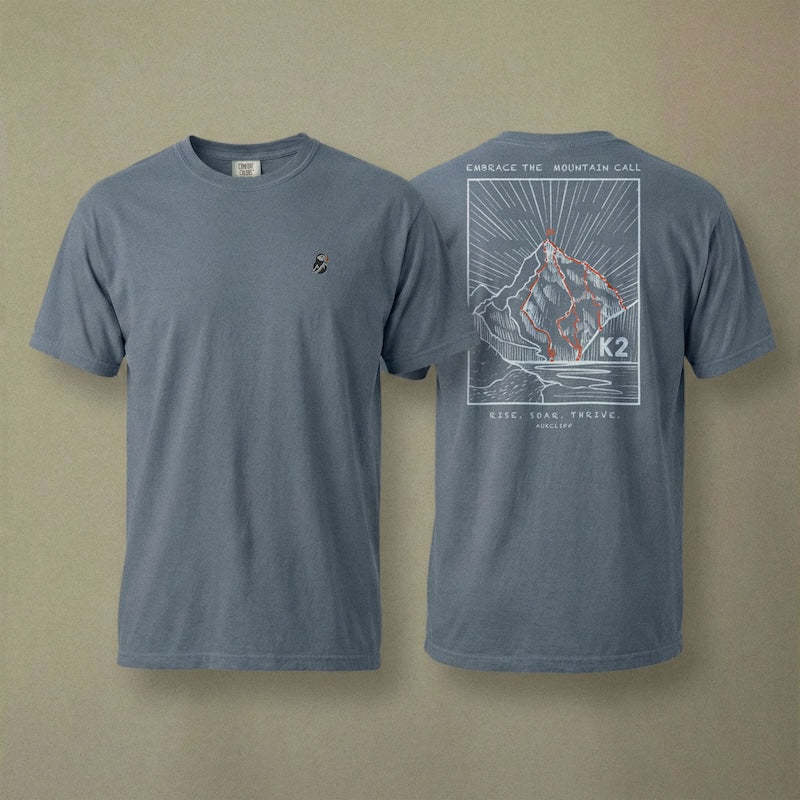 AukCliff K2 tee in Blue Jean, hand-drawn summit-route line art across the back