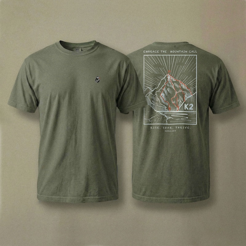 AukCliff K2 tee in Blue Jean, hand-drawn summit-route line art across the back