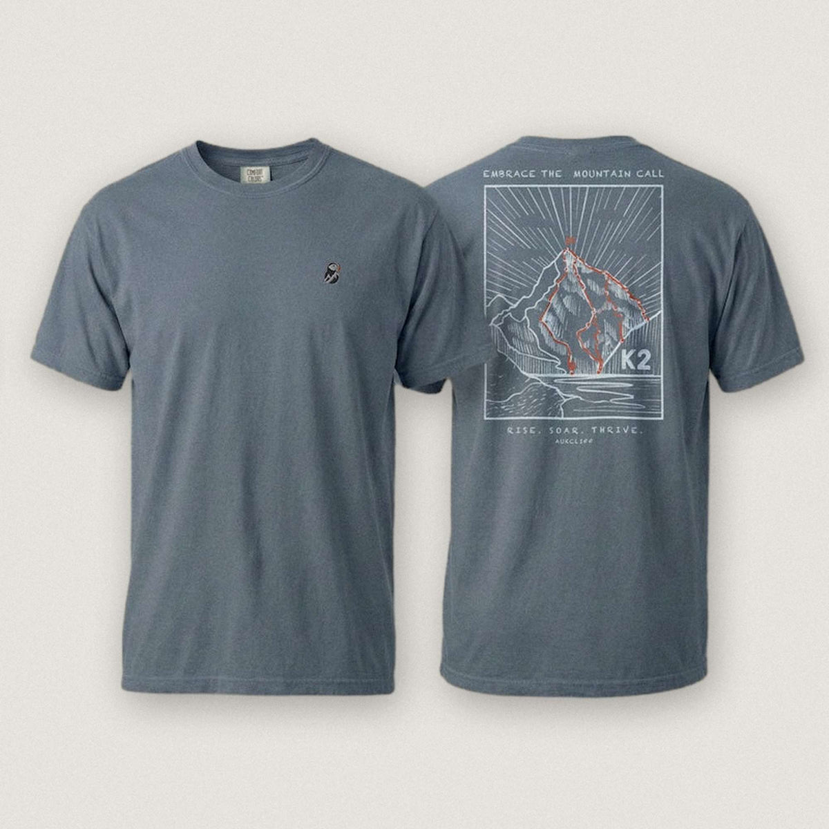 AukCliff K2 tee in Blue Jean, summit-route line art across the back