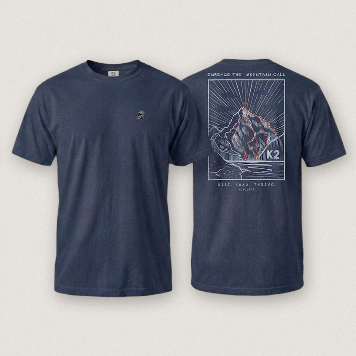 AukCliff K2 tee in True Navy, summit-route line art across the back