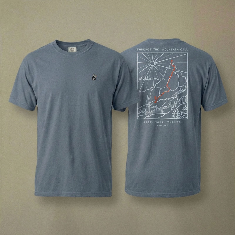 AukCliff Matterhorn tee in Blue Jean, hand-drawn ridgeline line art across the back