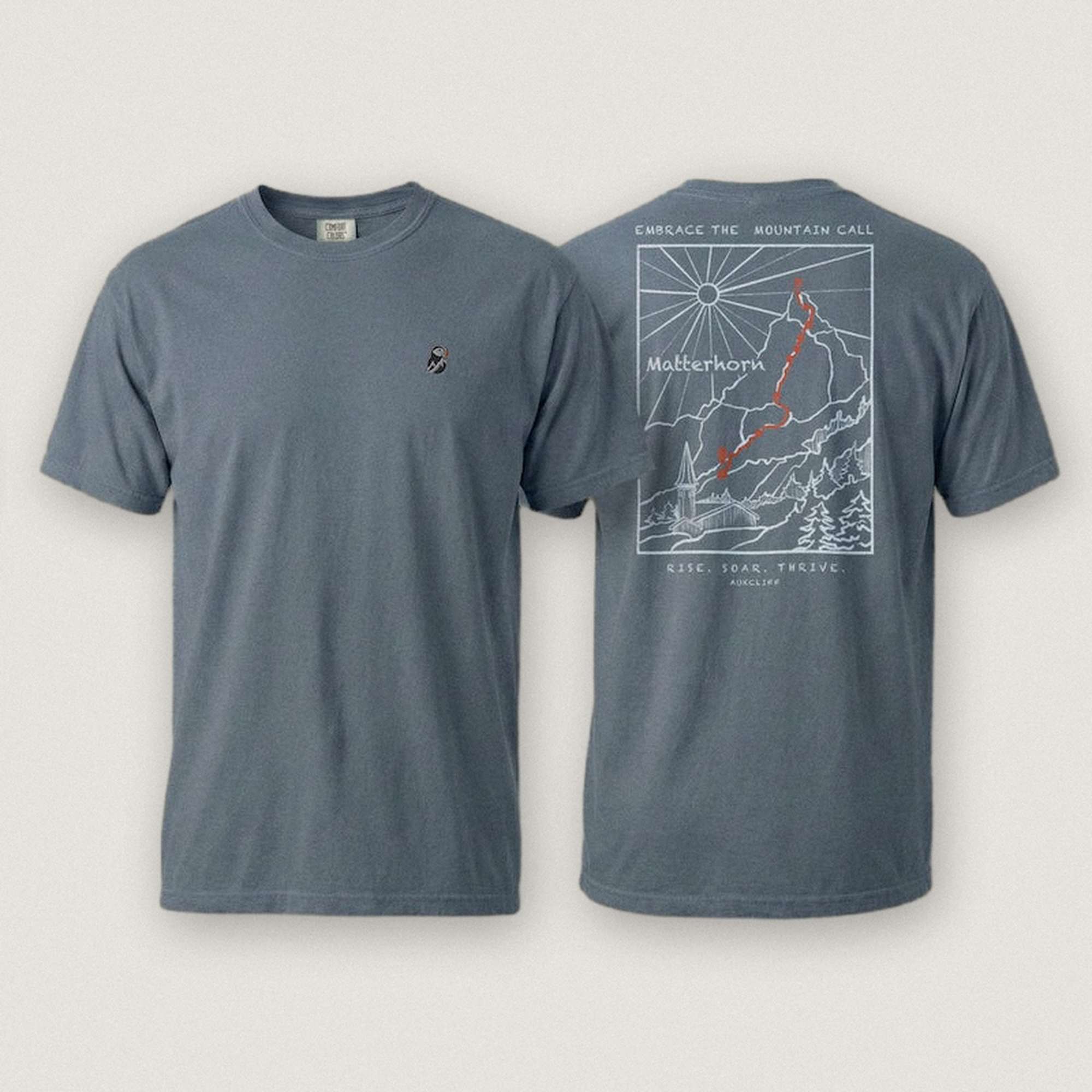 AukCliff Matterhorn tee in Blue Jean, hand-drawn ridgeline line art across the back