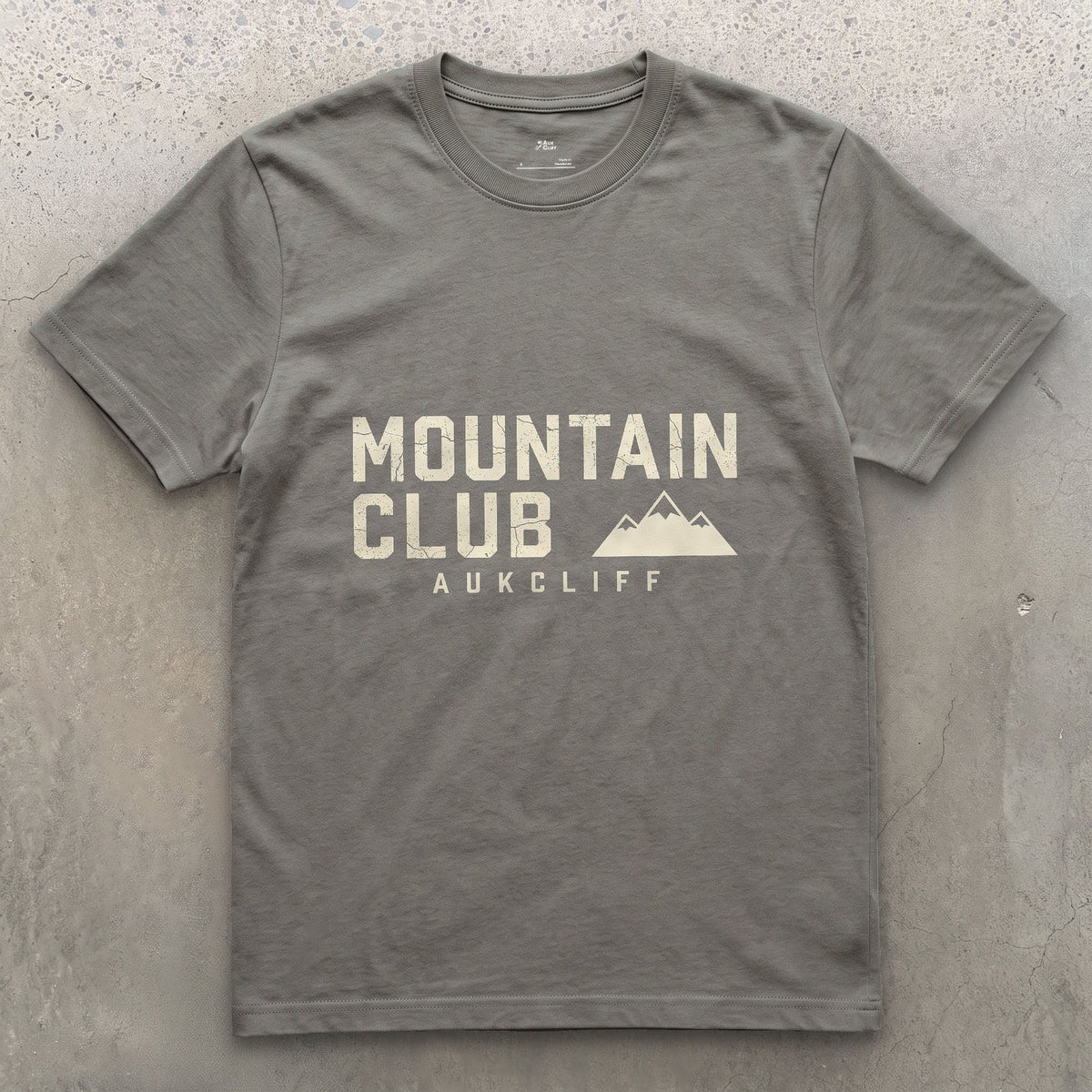 The Mountain Club Badge and Peak Icon design on a Charcoal Gildan Softstyle t-shirt