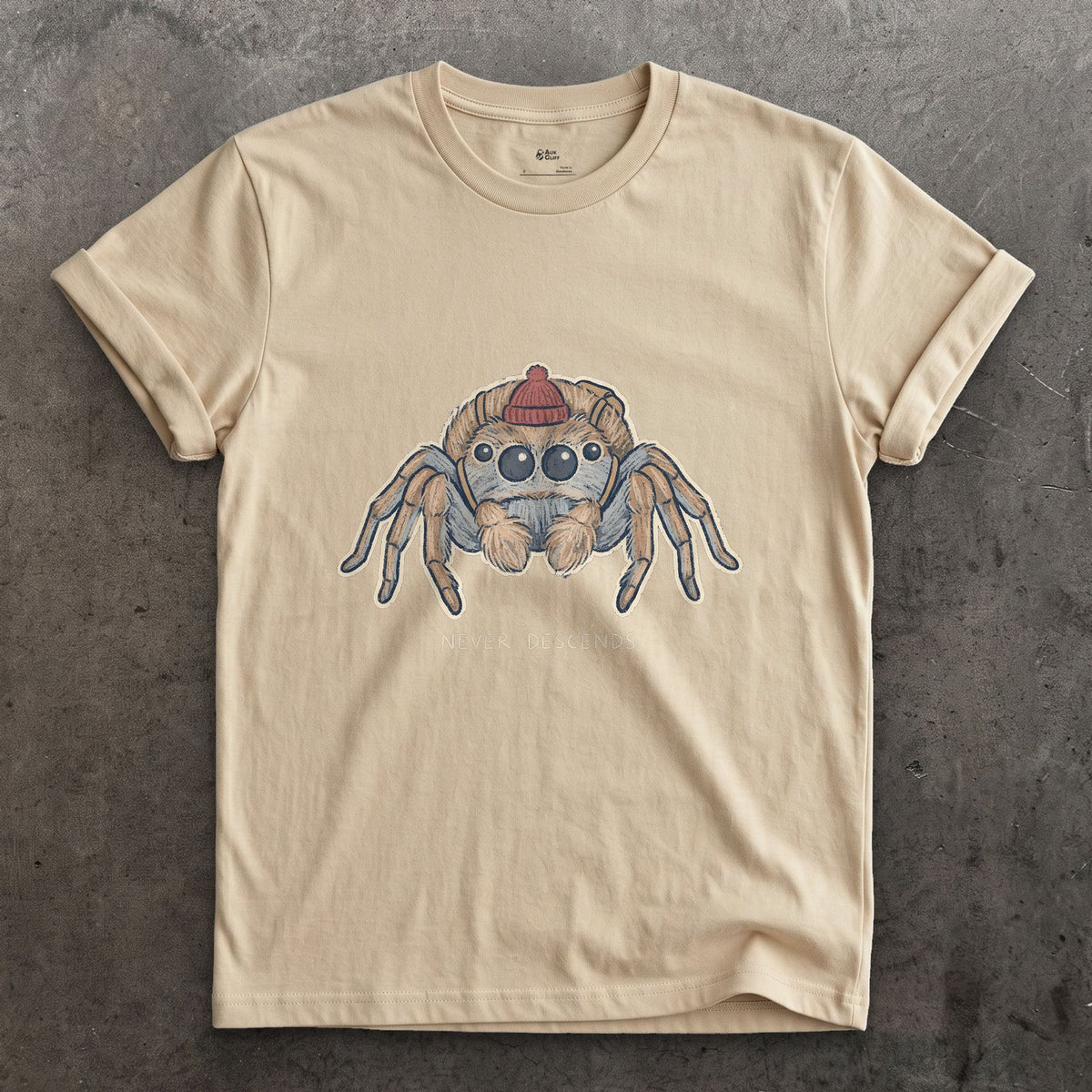 Spider, Climbs but Never Descends design on a Sand Gildan Softstyle t-shirt
