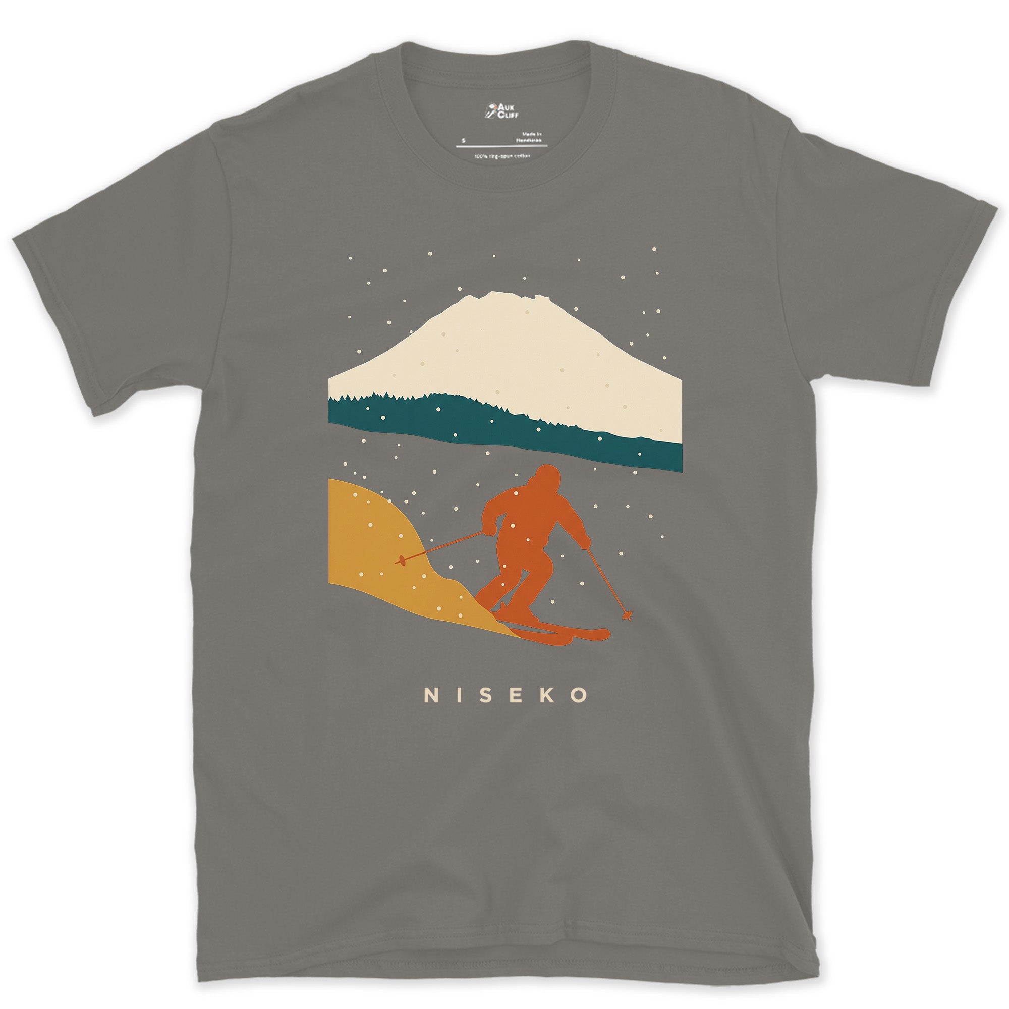 Niseko Skier Beneath the Snow Capped Volcano design on a Charcoal Gildan Softstyle t-shirt