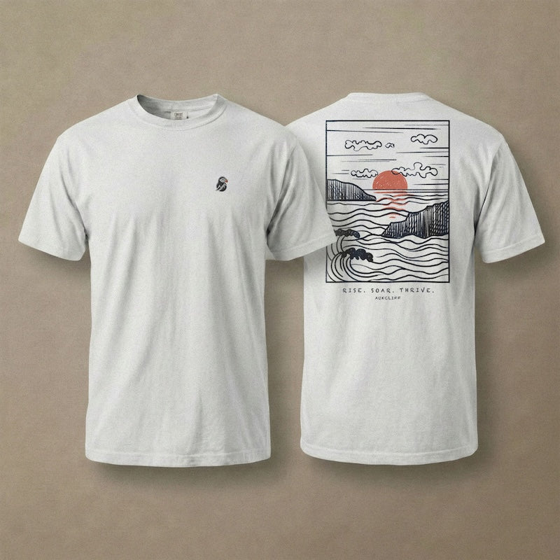 AukCliff Ocean Sunset Waves tee in White, hand-drawn sunset and waves line art across the back