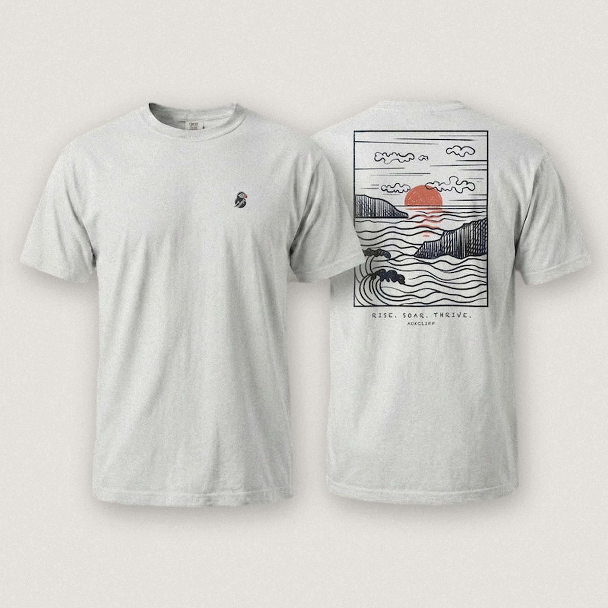 AukCliff Ocean Sunset Waves tee in White, hand-drawn sunset and waves line art across the back
