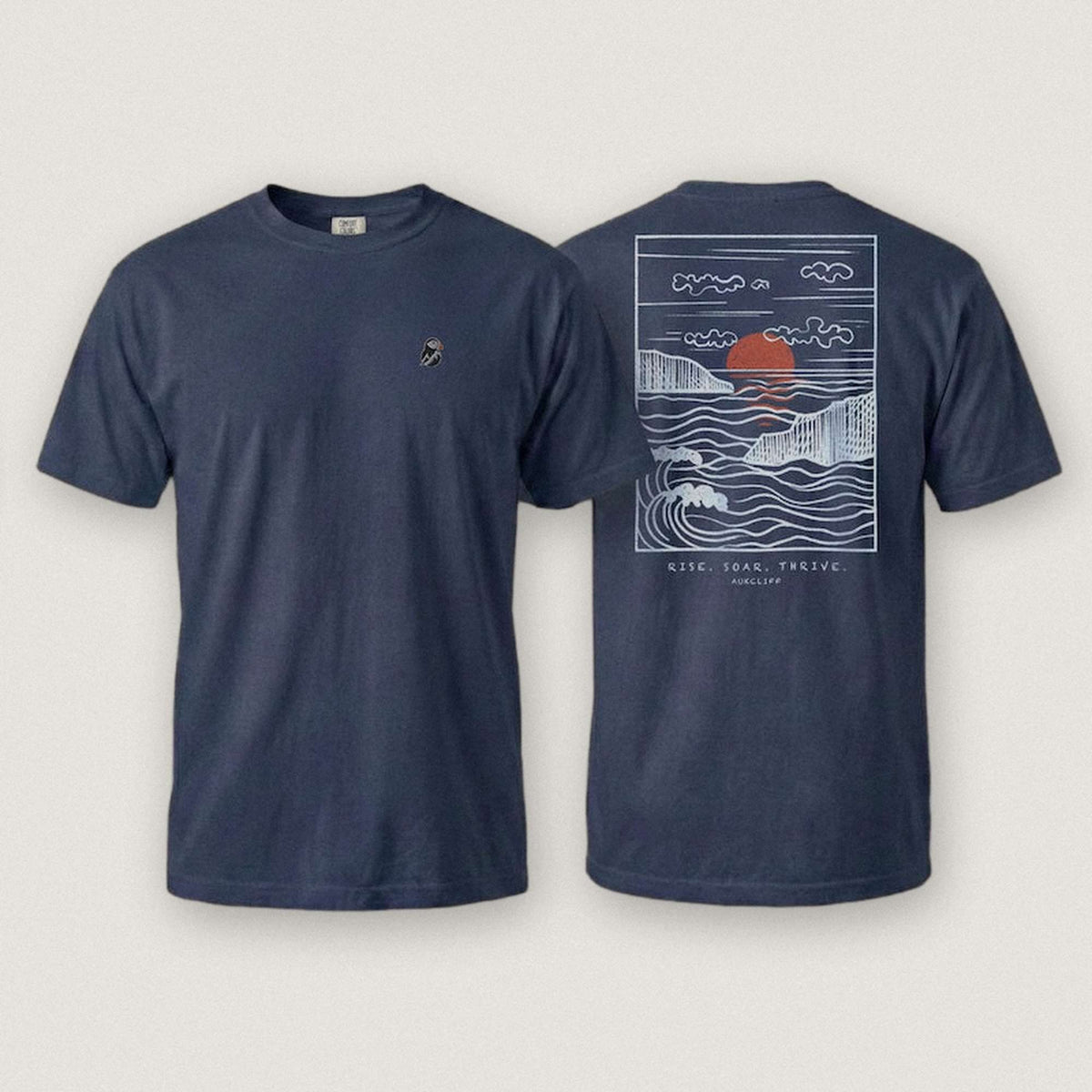 AukCliff Ocean Sunset Waves tee in True Navy, sunset and waves line art across the back