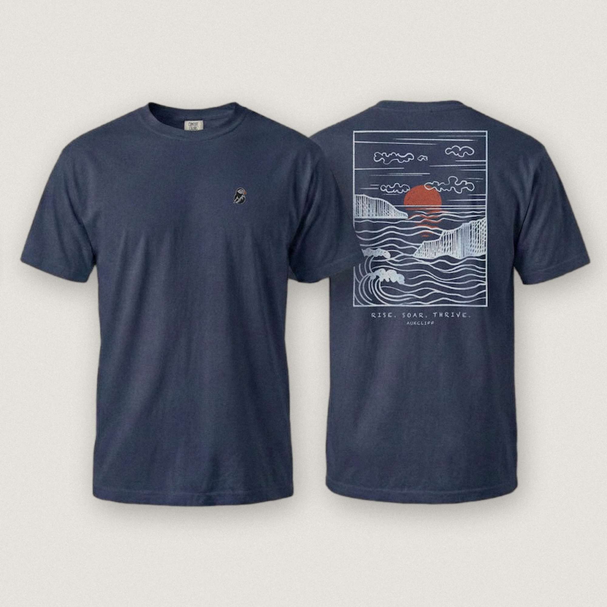 AukCliff Ocean Sunset Waves tee in True Navy, hand-drawn sunset and waves line art across the back