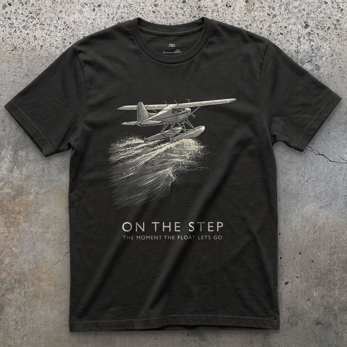 On the Step, the Float Lets Go design on a Black Gildan Softstyle t-shirt