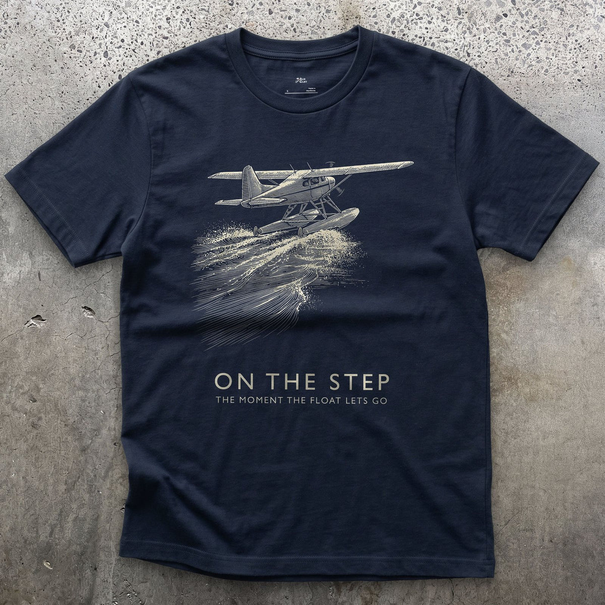 On the Step, the Float Lets Go design on a Navy Gildan Softstyle t-shirt