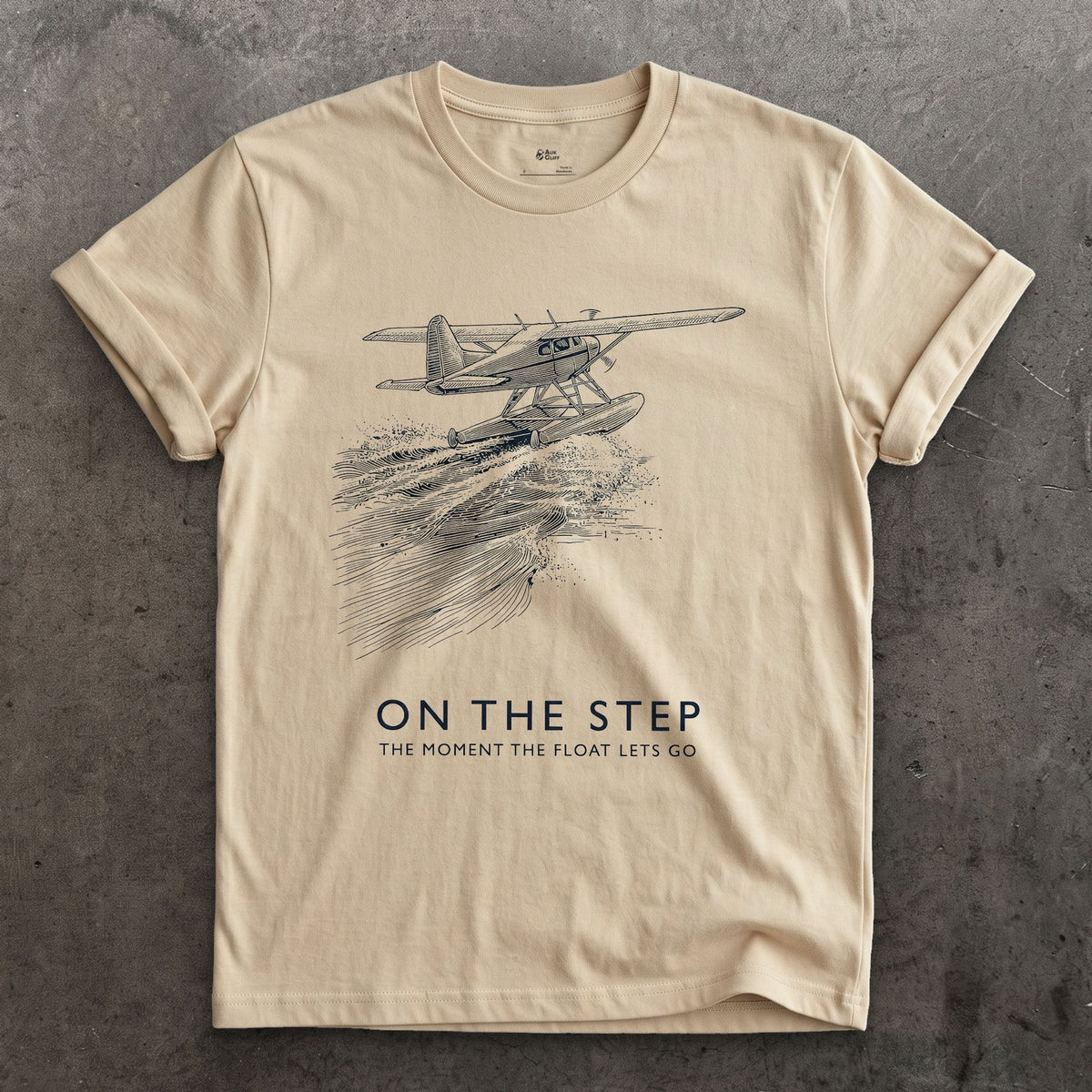 On the Step, the Float Lets Go design on a Sand Gildan Softstyle t-shirt