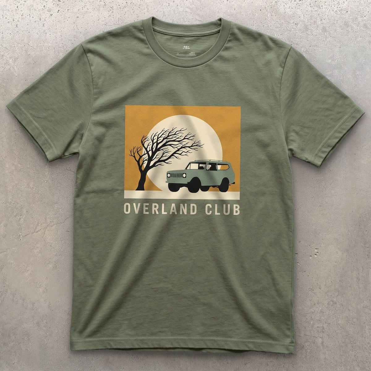 Overland Club, Bare Tree Under a Full Moon design on a Military Green Gildan Softstyle t-shirt