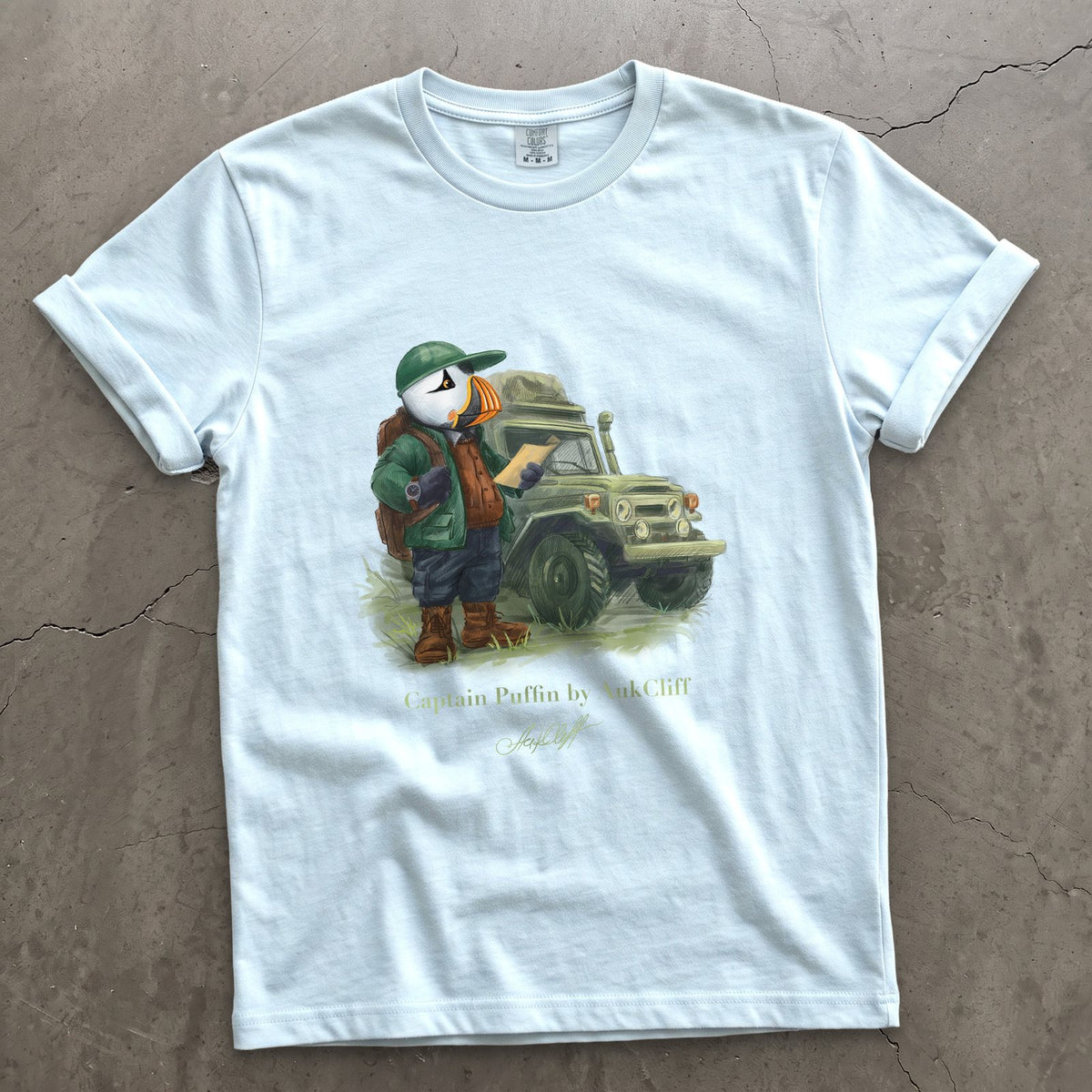 Captain Puffin Overland Explorer on a Chambray Comfort Colors t-shirt