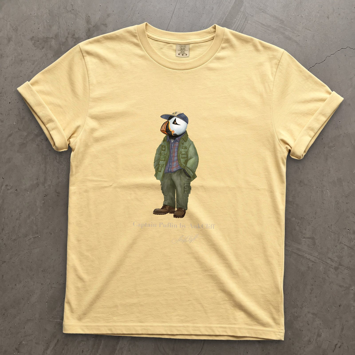 Captain Puffin Pacific Northwest Trailkeeper on a Butter Comfort Colors t-shirt