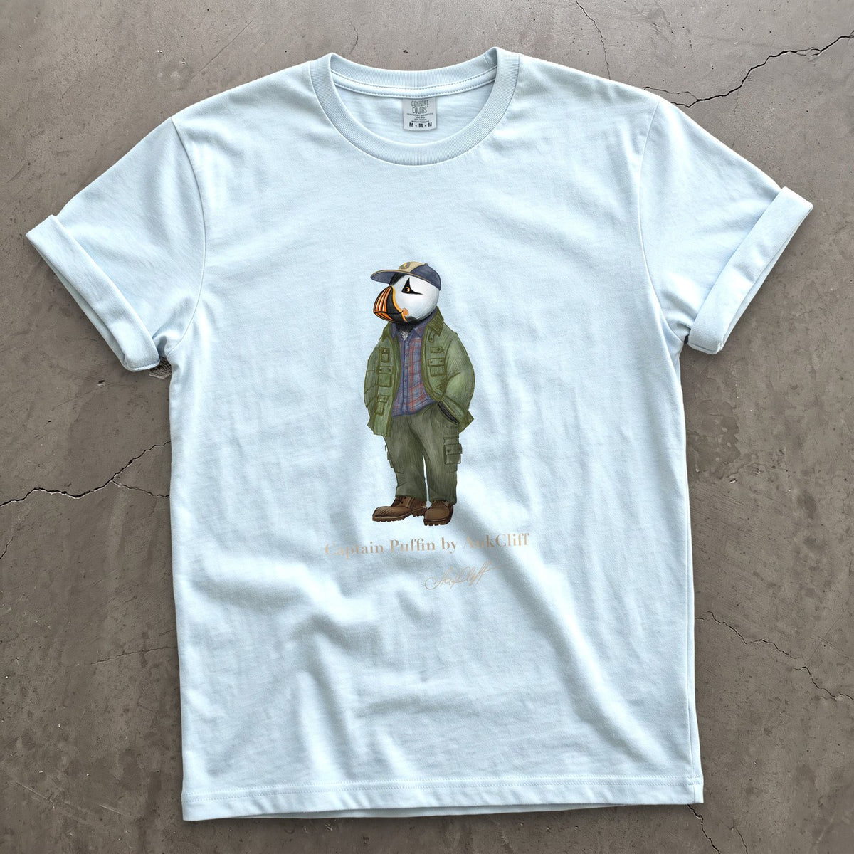 Captain Puffin Pacific Northwest Trailkeeper on a Chambray Comfort Colors t-shirt