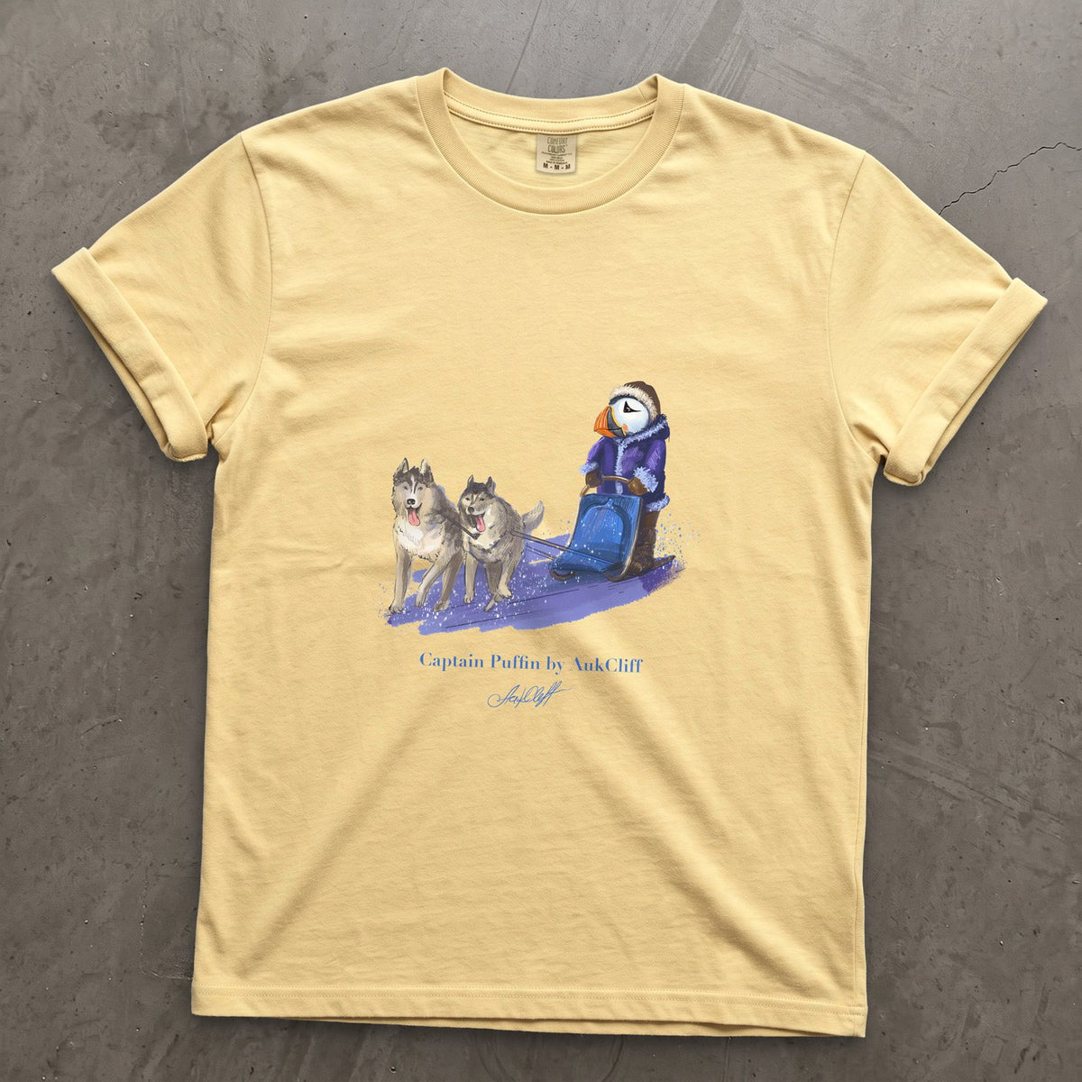 Captain Puffin Arctic Dog Sledder on a Butter Comfort Colors t-shirt
