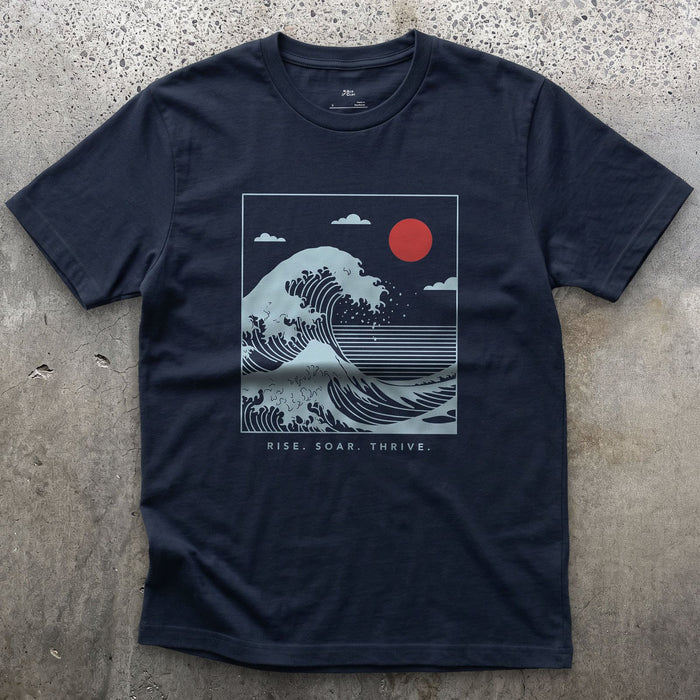 Rise, Soar, Thrive, the Cresting Wave design on a Navy Gildan Softstyle t-shirt