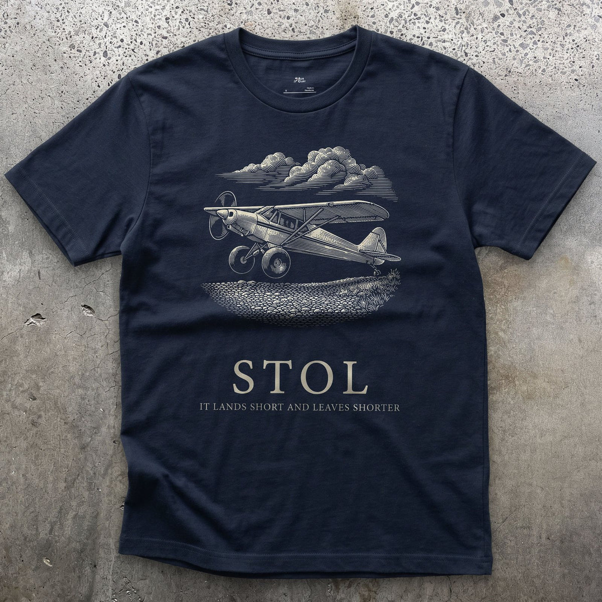 STOL, Short Take Off and Landing design on a Navy Gildan Softstyle t-shirt