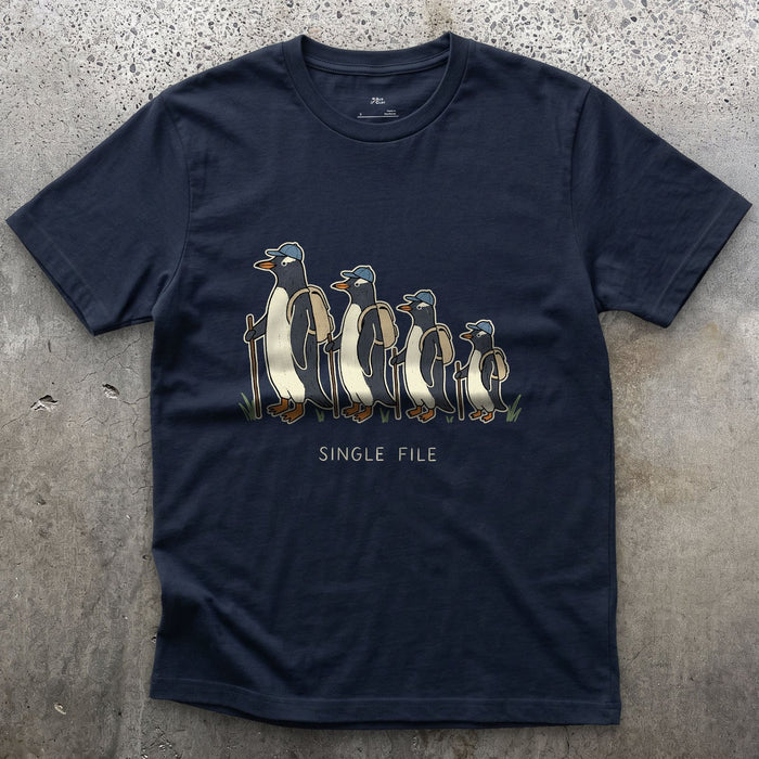 Single File, Penguins in the Same Track design on a Navy Gildan Softstyle t-shirt