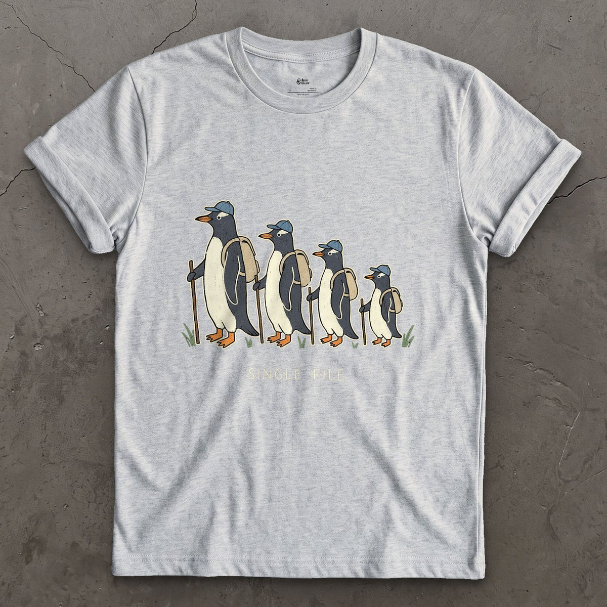 Single File, Penguins in the Same Track design on a Sport Grey Gildan Softstyle t-shirt
