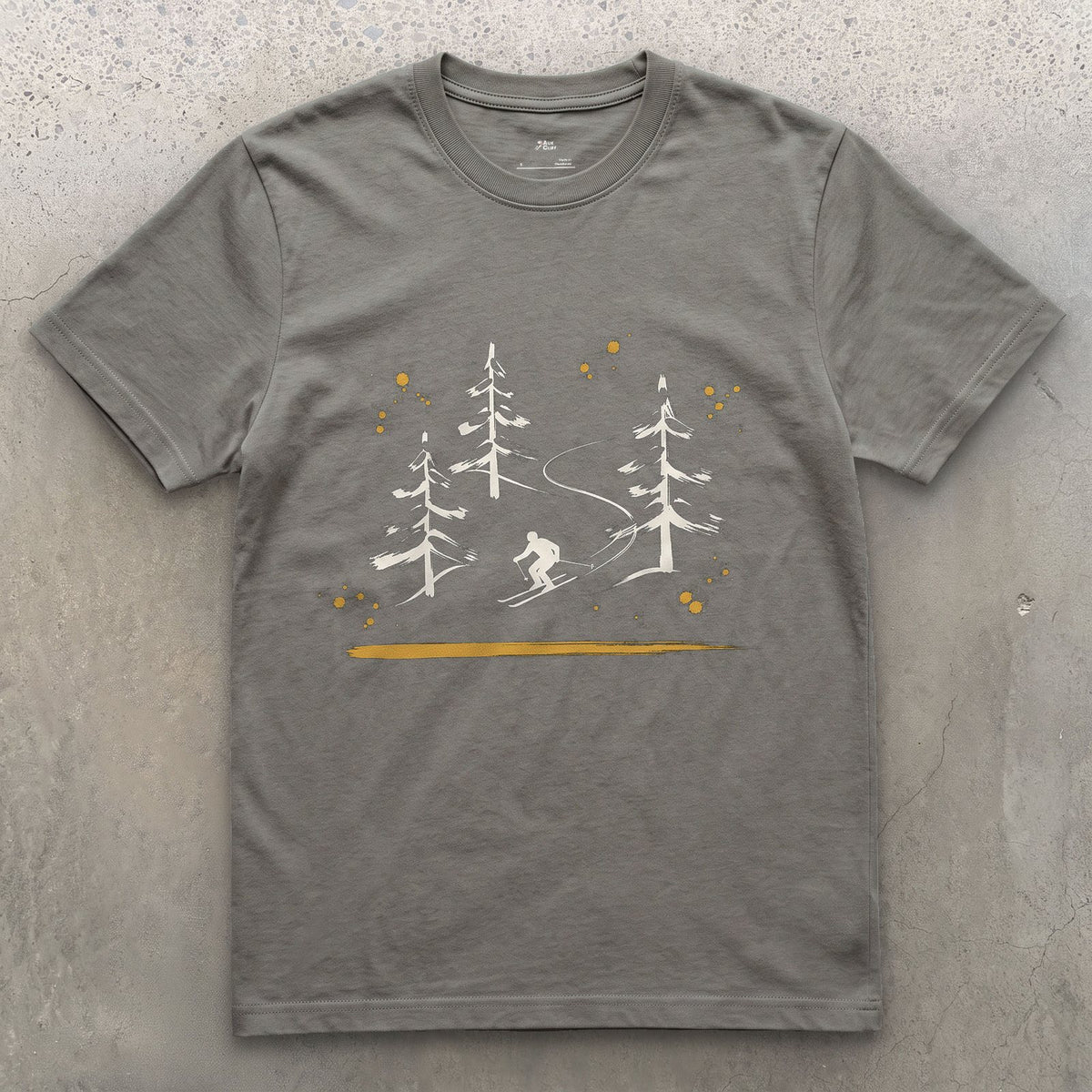 Skier Through the Pines design on a Charcoal Gildan Softstyle t-shirt