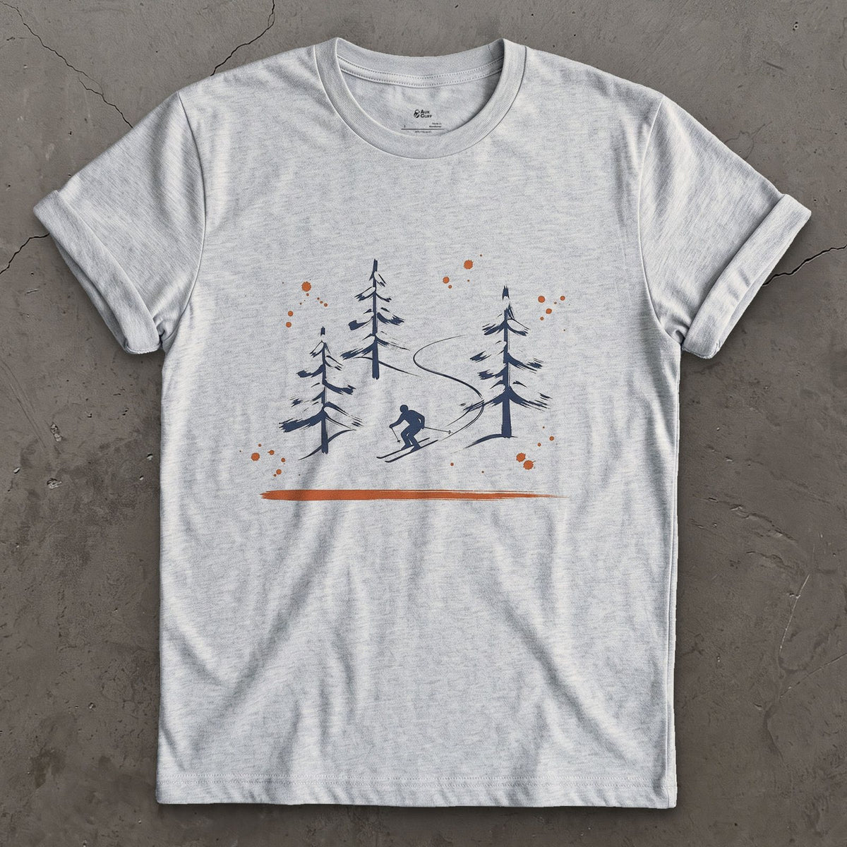 Skier Through the Pines design on a Sport Grey Gildan Softstyle t-shirt