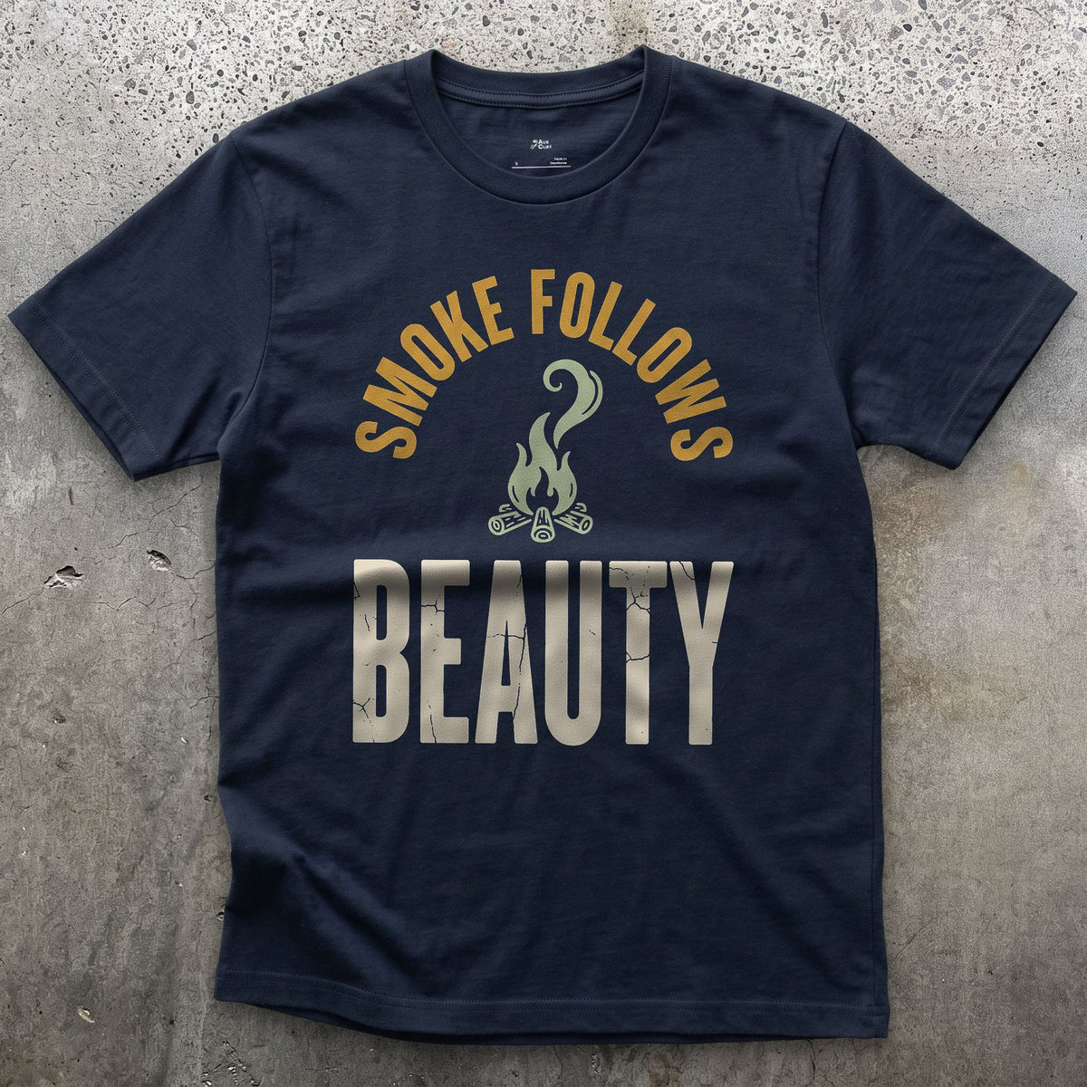 Smoke Follows Beauty, Rising Smoke Badge design on a Navy Gildan Softstyle t-shirt
