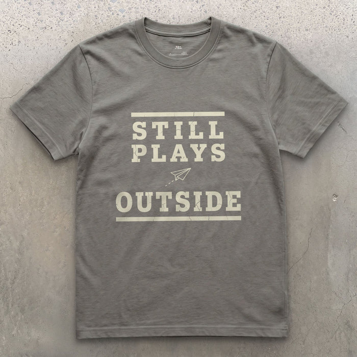 Still Plays Outside, Paper Airplane and All design on a Charcoal Gildan Softstyle t-shirt