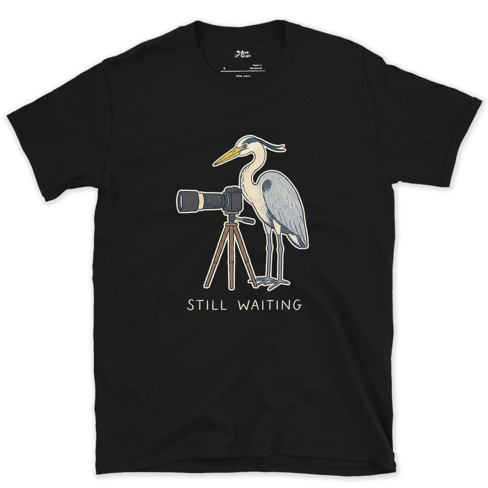 Still Waiting on the Tripod, a Heron Habit design on a Black Gildan Softstyle t-shirt