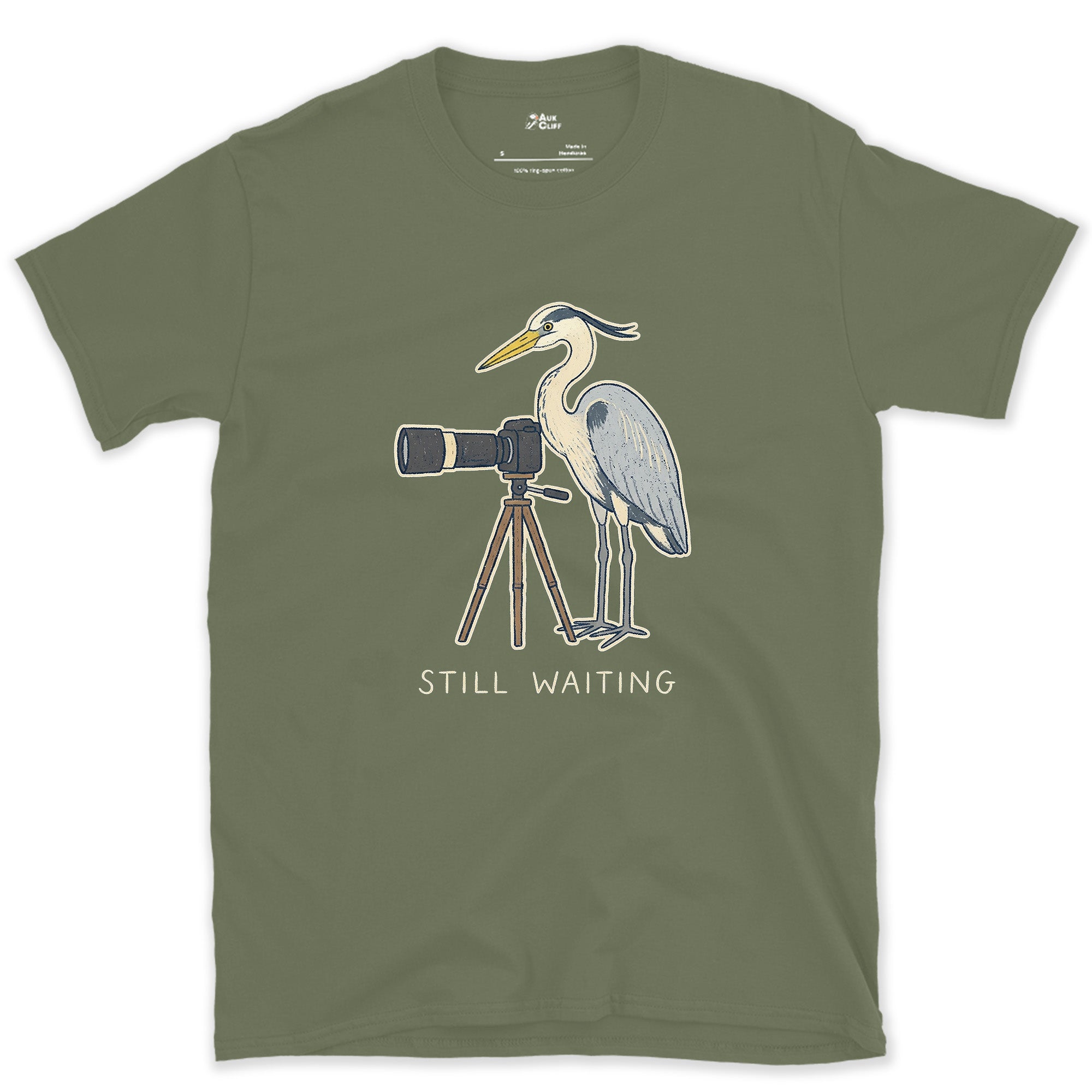 Still Waiting on the Tripod, a Heron Habit design on a Military Green Gildan Softstyle t-shirt