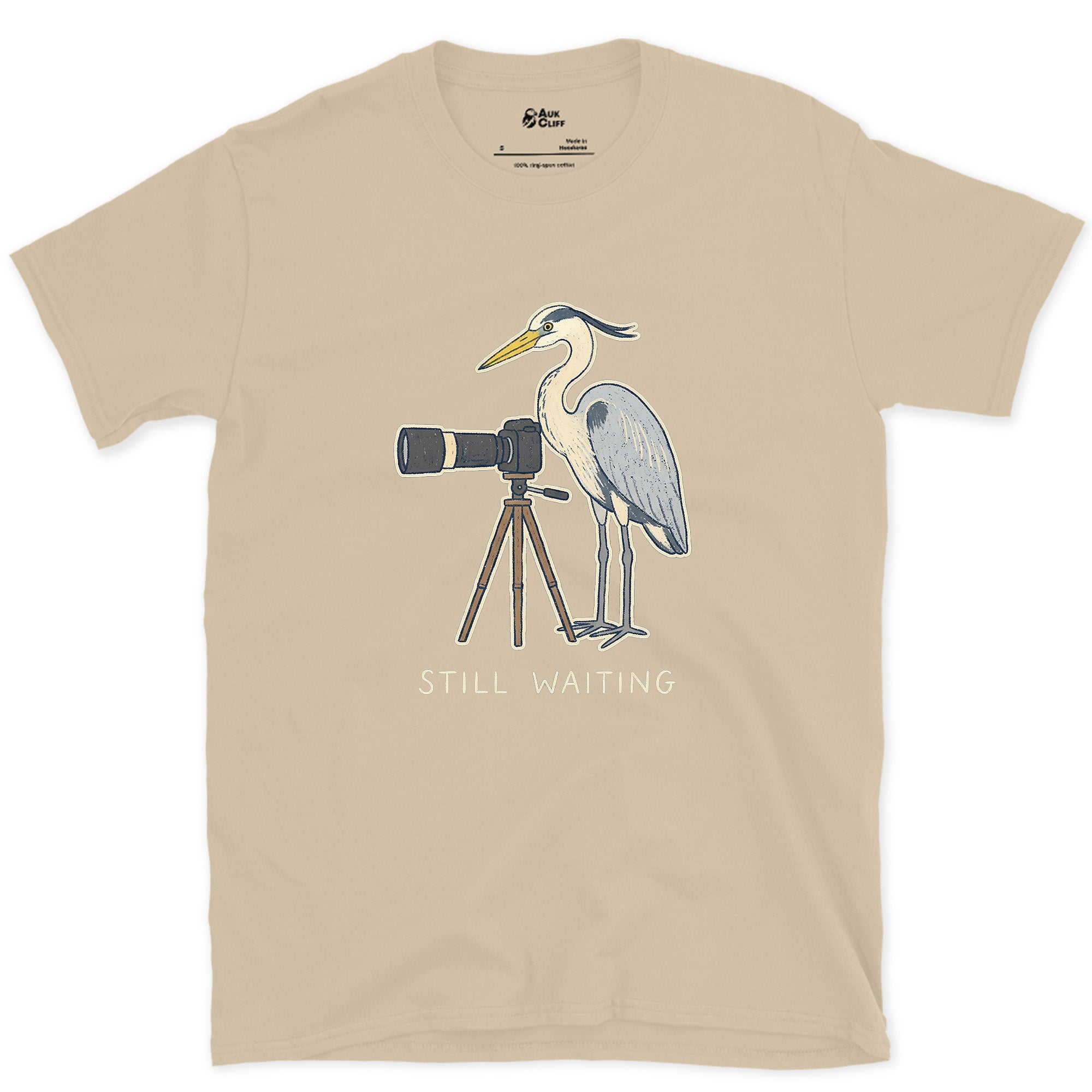 Still Waiting on the Tripod, a Heron Habit design on a Sand Gildan Softstyle t-shirt