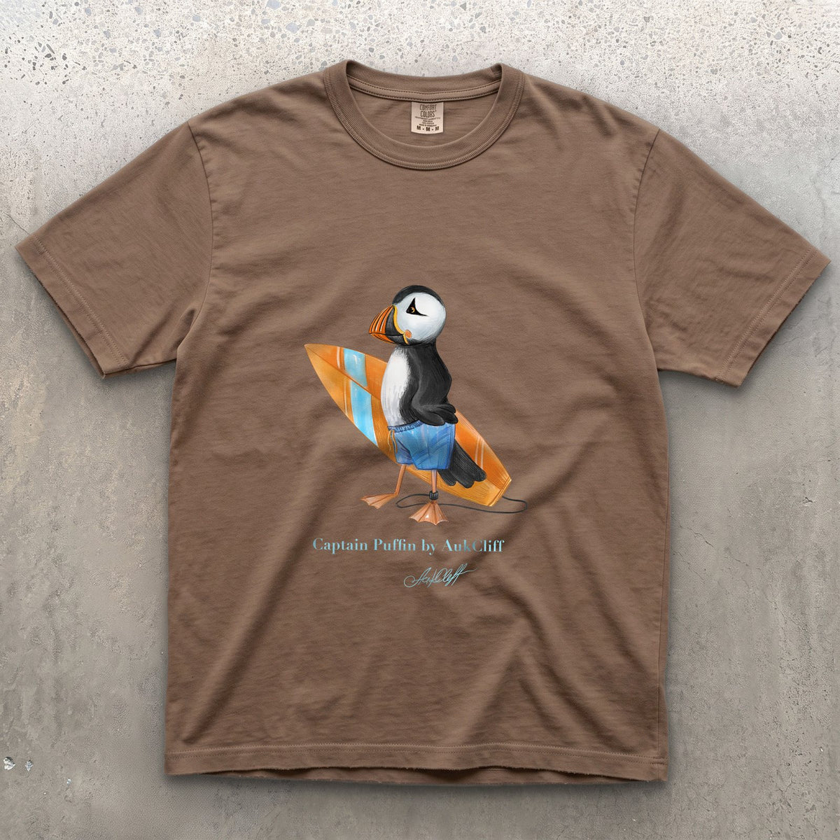 Captain Puffin Surfer on a Espresso Comfort Colors t-shirt